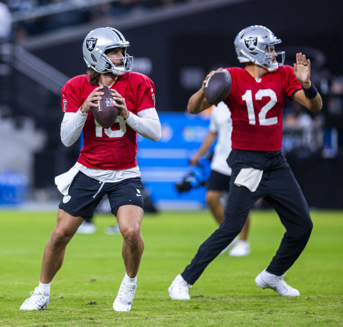 Raiders quarterback Gardner Minshew (15) and quarterback Aidan O'Connell (12) both drop back to ...