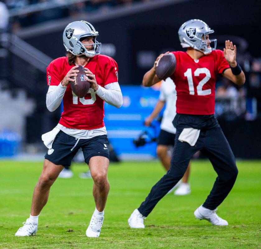 Raiders quarterback Gardner Minshew (15) and quarterback Aidan O'Connell (12) both drop back to ...