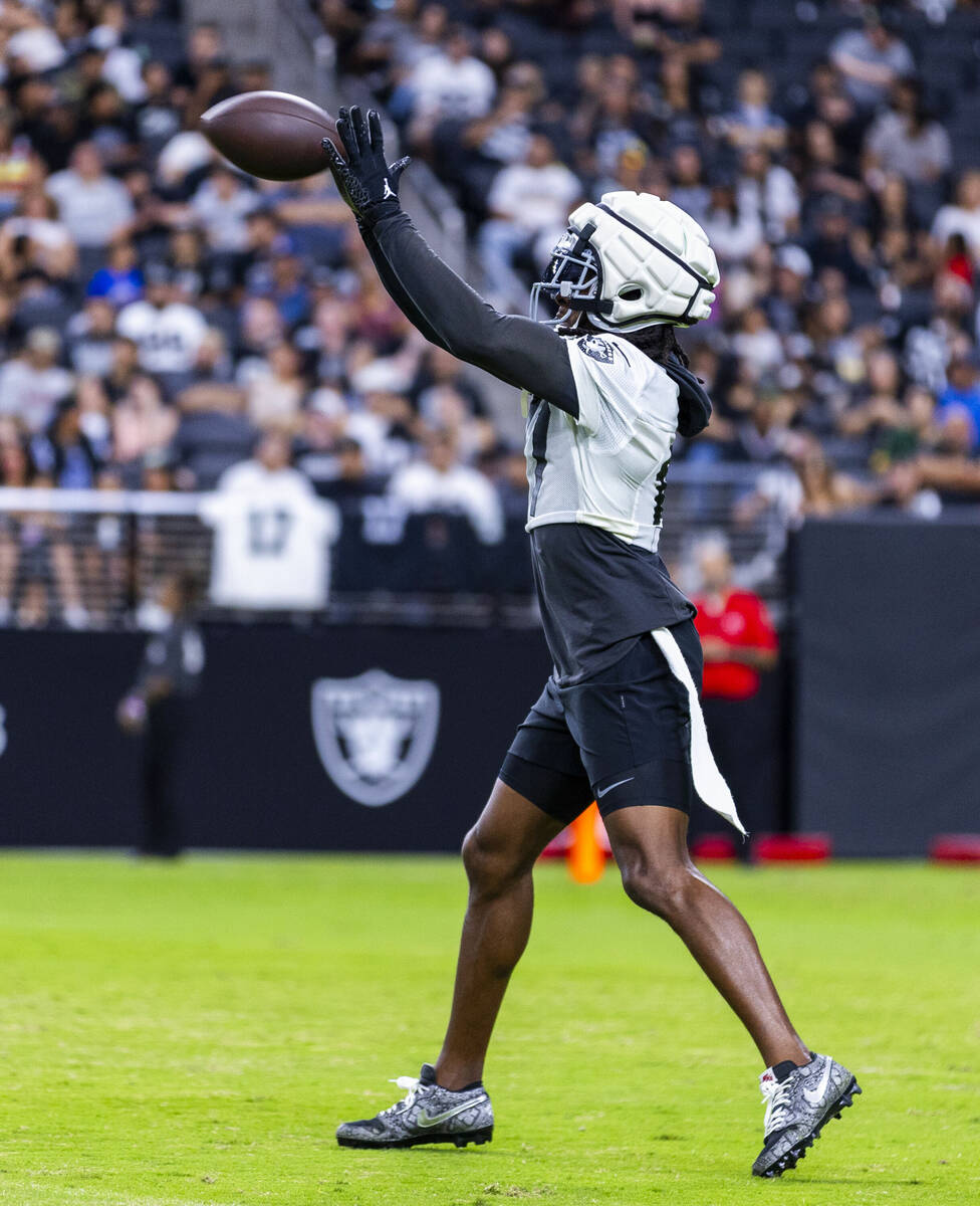 Raiders wide receiver Davante Adams (17) makes a catch during an open practice at Allegiant Sta ...