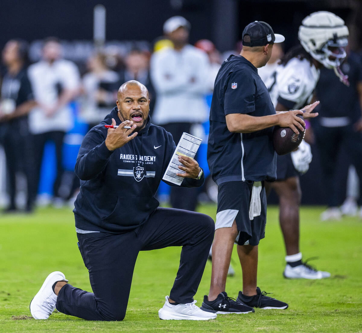 Raiders head coach Antonio Pierce directs players during an open practice at Allegiant Stadium ...