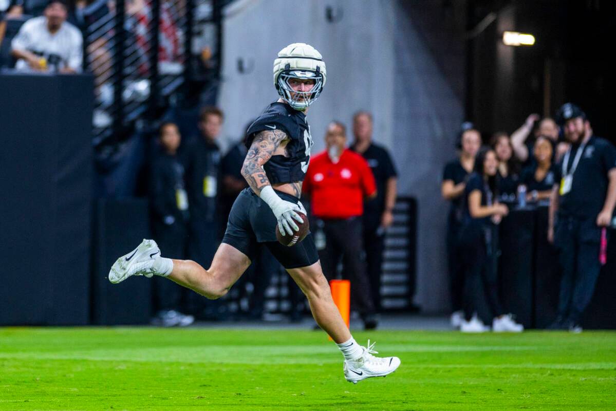 Raiders defensive end Maxx Crosby (98) runs the entire field for a score after an interception ...