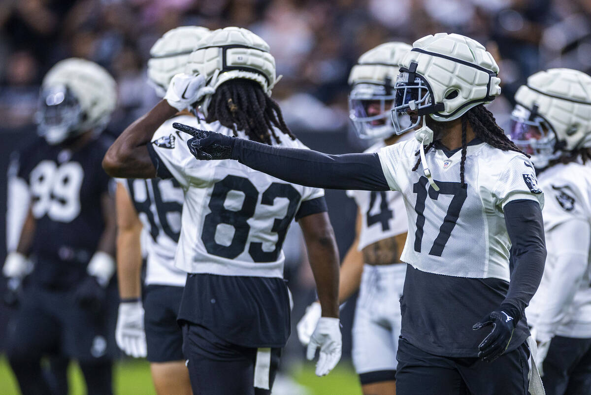 Raiders wide receiver Davante Adams (17) directs a teammate during an open practice at Allegian ...