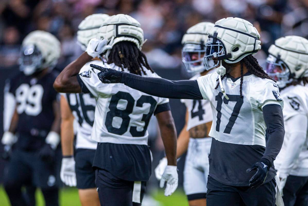 Raiders wide receiver Davante Adams (17) directs a teammate during an open practice at Allegian ...