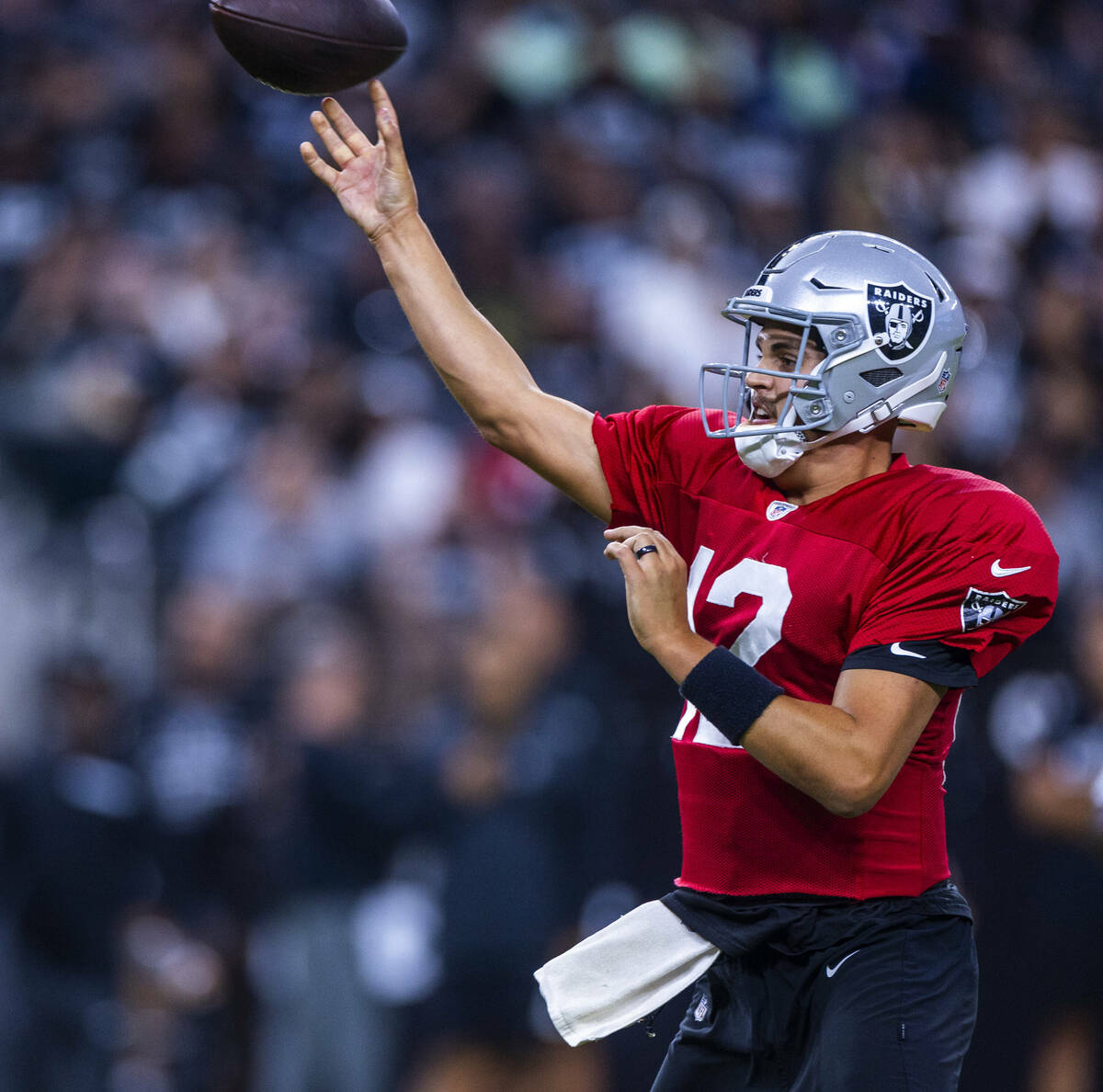 Raiders quarterback Aidan O'Connell (12) gets off a pass during an open practice at Allegiant S ...