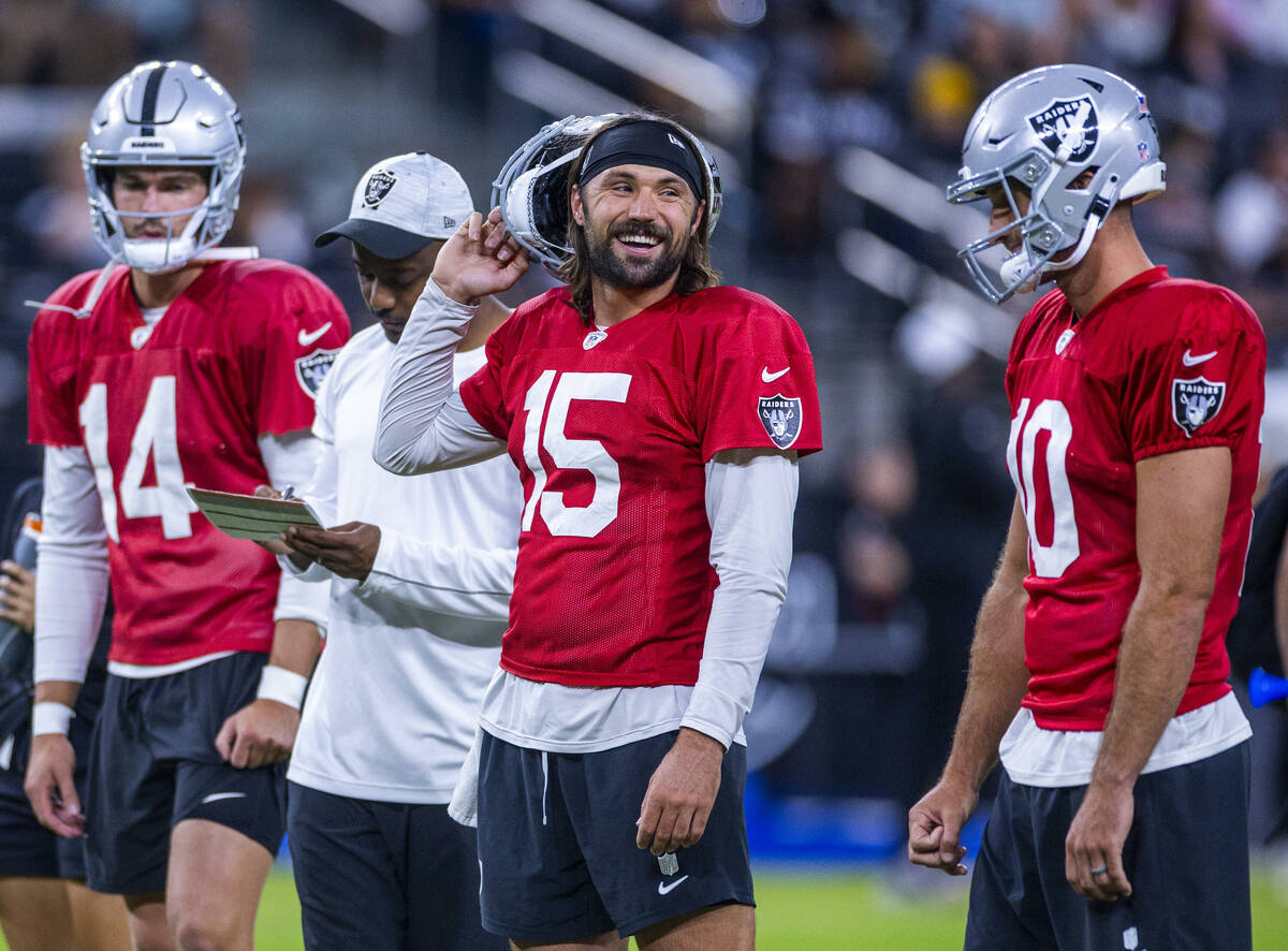 Raiders quarterback Gardner Minshew (15) laughs with quarterback Nathan Peterman (10) during an ...