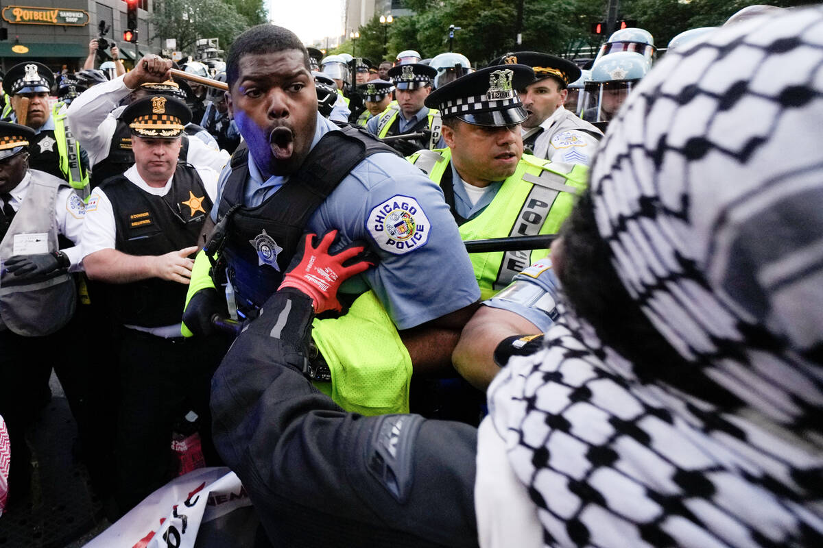 Demonstrators clash with police near the Israeli Consulate during the Democratic National Conve ...