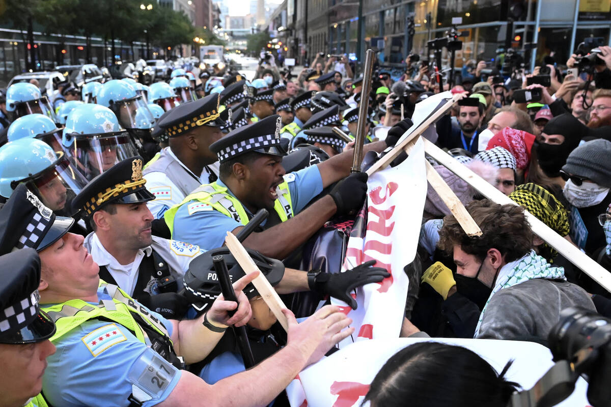 Demonstrators clash with police near the Israeli Consulate during the Democratic National Conve ...