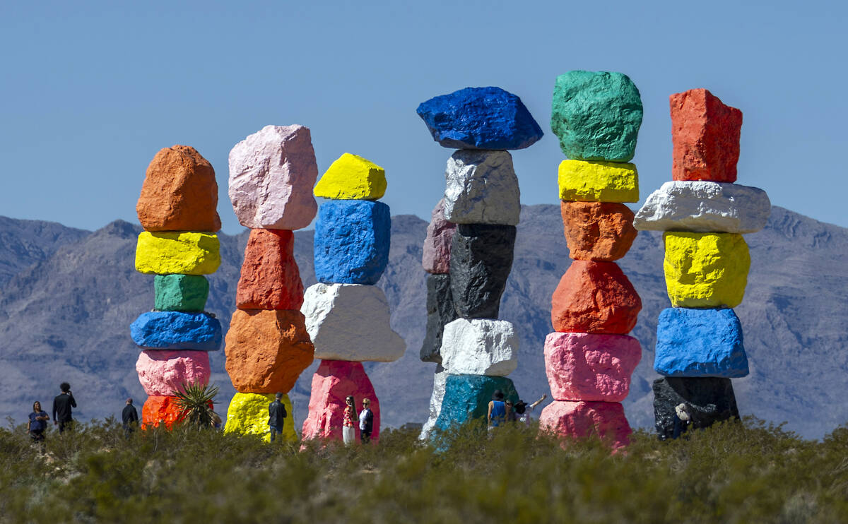 Visitors stop by to see the Seven Magic Mountains art installation on Wednesday, March 20, 2024 ...