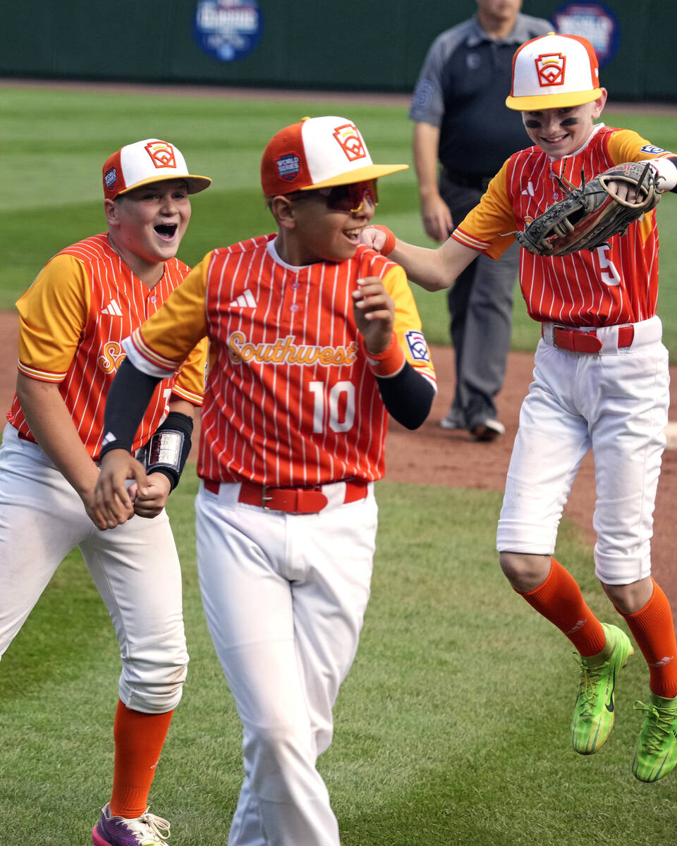 Boerne, Texas' Cooper Hastings, left, Aiden Munoz (10) and Jet Matthews (5) celebrate after get ...