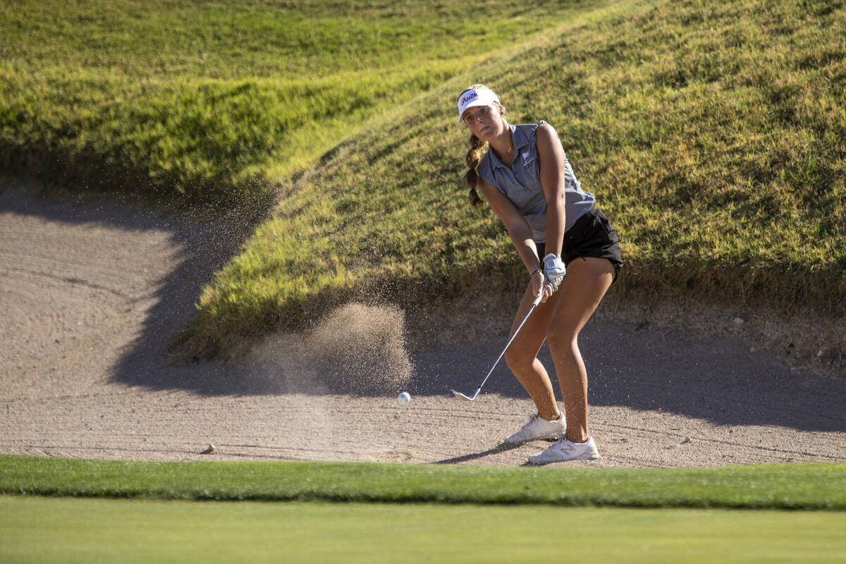 Faith Lutheran’s Scarlett Schneider attempts to chip onto the green from the bunker duri ...