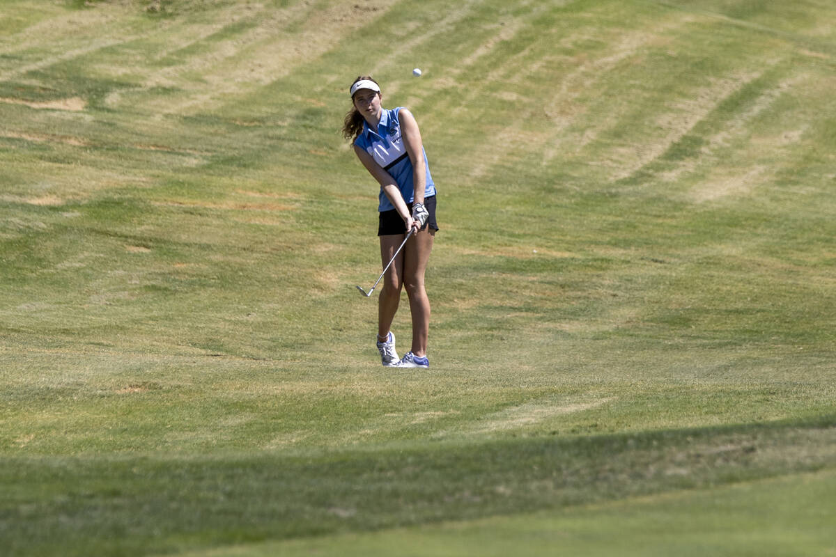 Centennial’s Mia Meyers chips her ball toward the green during the 5A Desert League girl ...