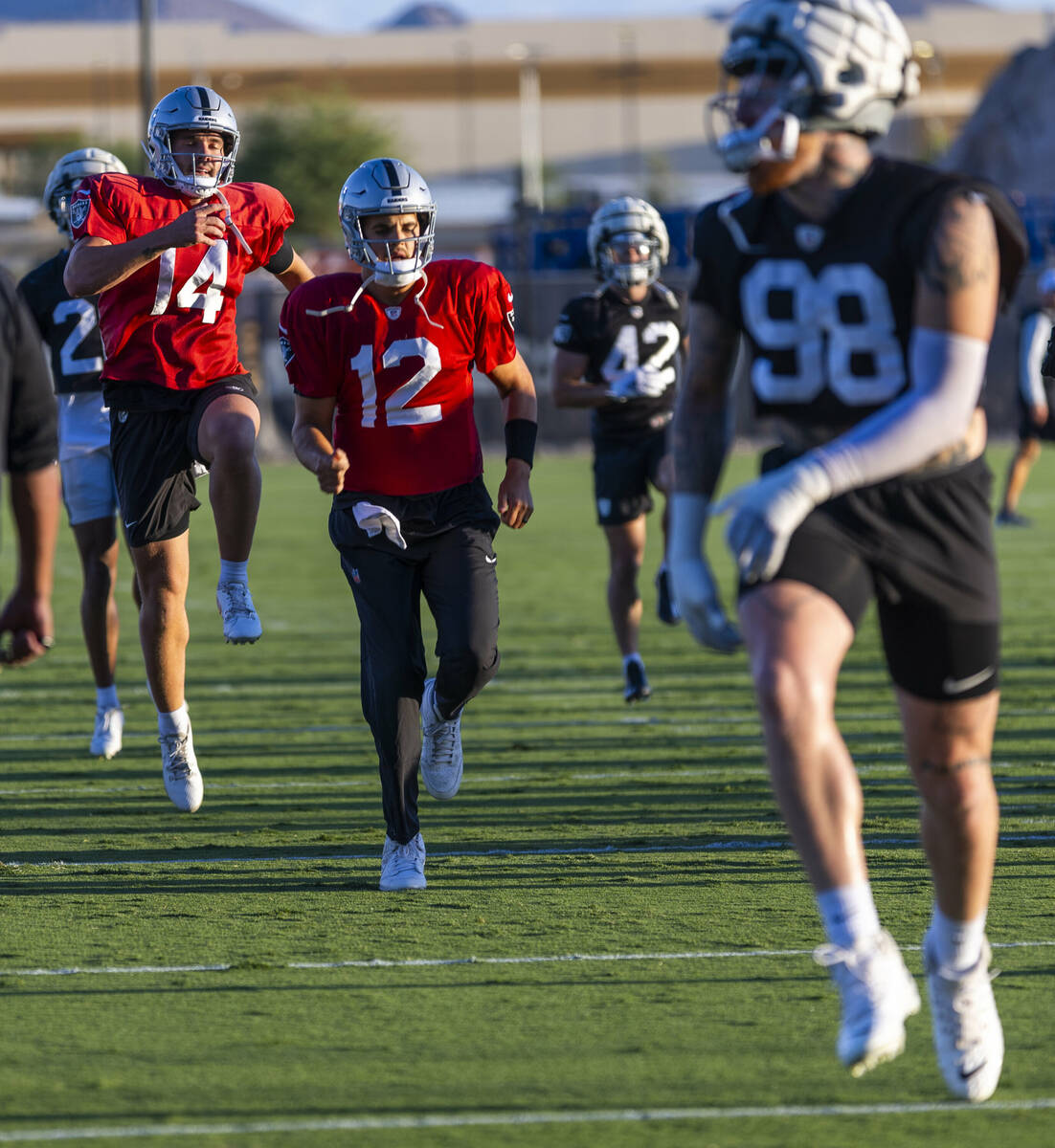 Raiders quarterback Carter Bradley (14) catches some air beside quarterback Aidan O'Connell (12 ...