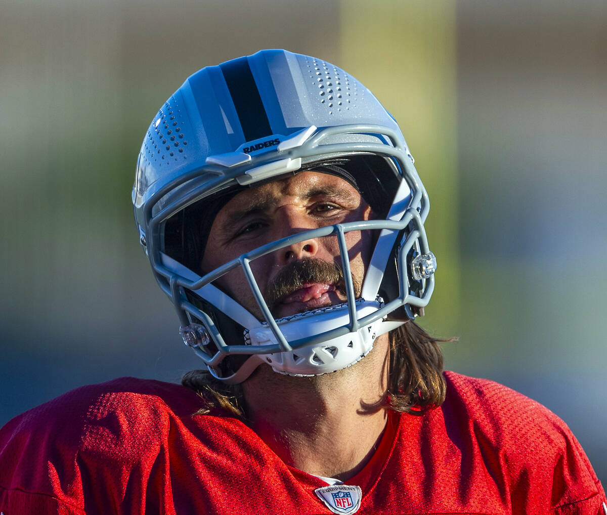 Raiders quarterback Gardner Minshew (15) sticks his tongue out during practice at the Intermoun ...