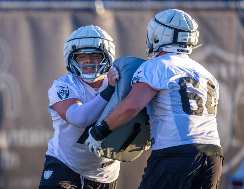 Raiders guard Jackson Powers-Johnson (70) and guard Clark Barrington (64) on a drill during pra ...