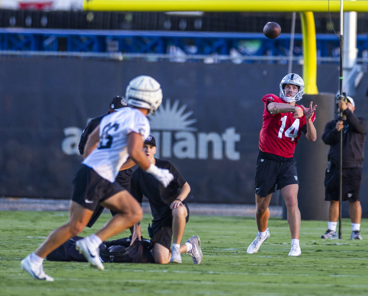 Raiders quarterback Carter Bradley (14) passes to tight end John Samuel Shenker (86) during pra ...