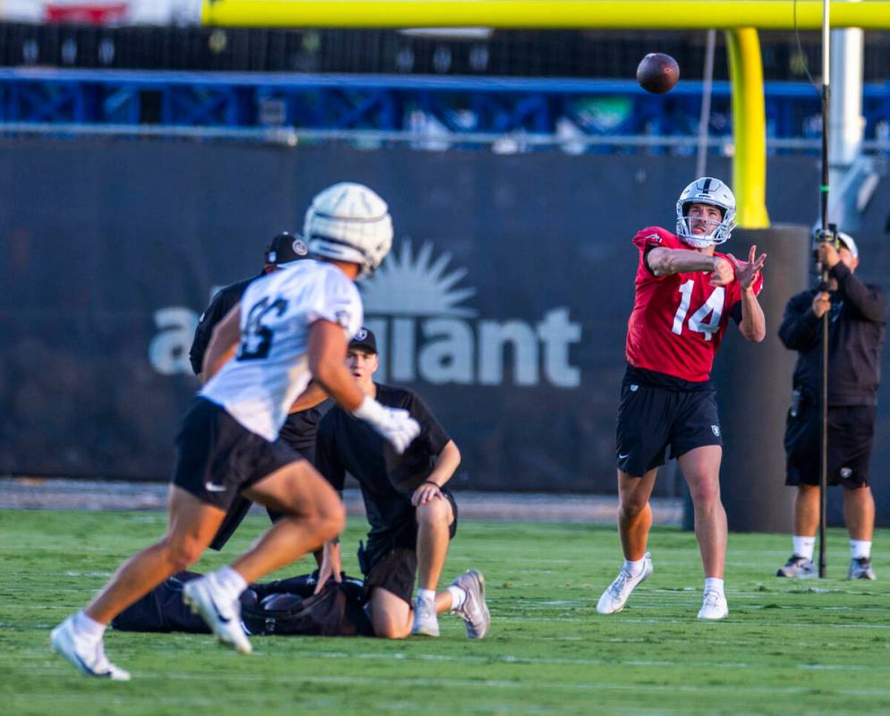 Raiders quarterback Carter Bradley (14) passes to tight end John Samuel Shenker (86) during pra ...