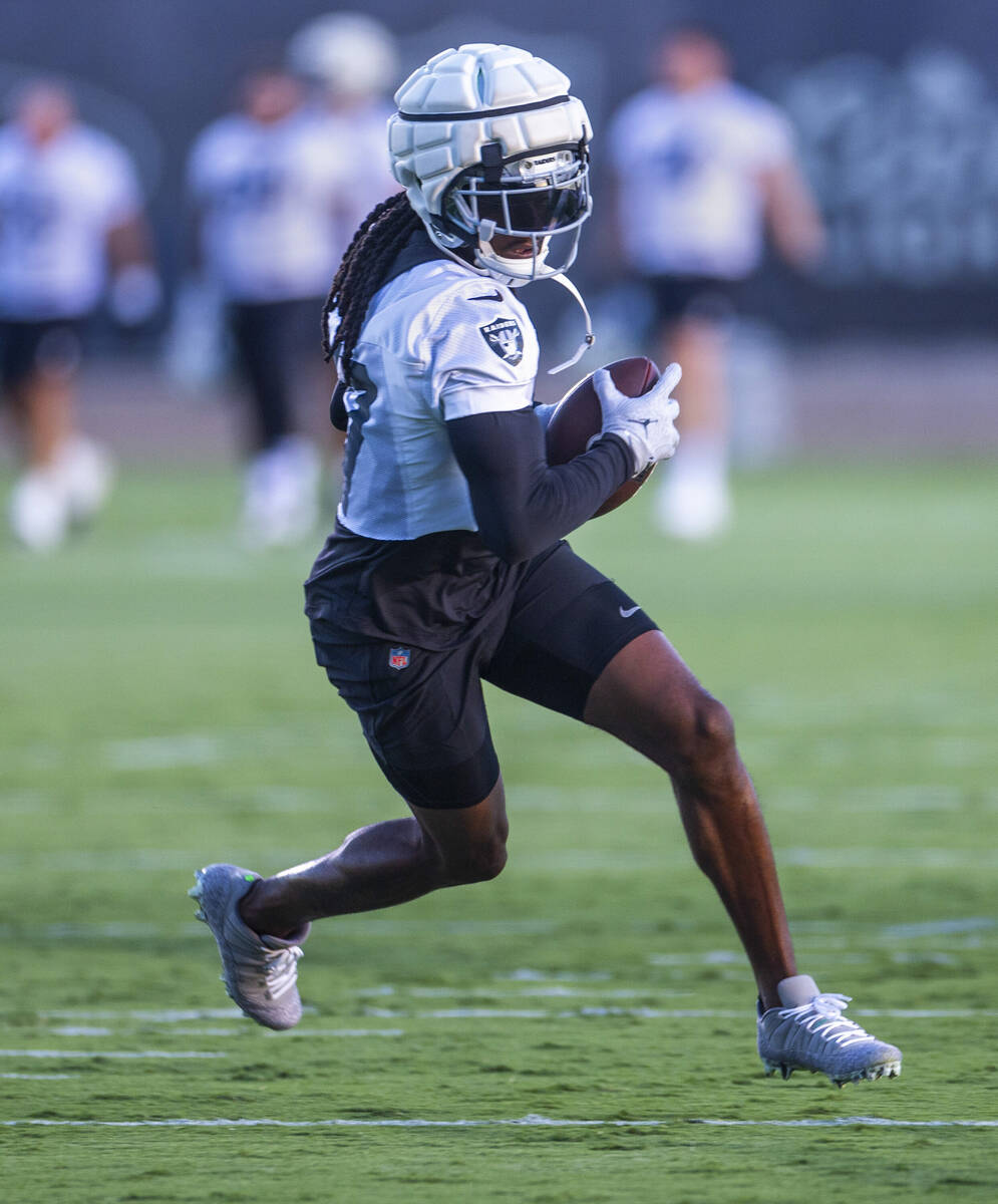 Raiders wide receiver Davante Adams (17) catches a pass during practice at the Intermountain He ...