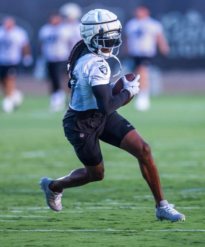 Raiders wide receiver Davante Adams (17) catches a pass during practice at the Intermountain He ...