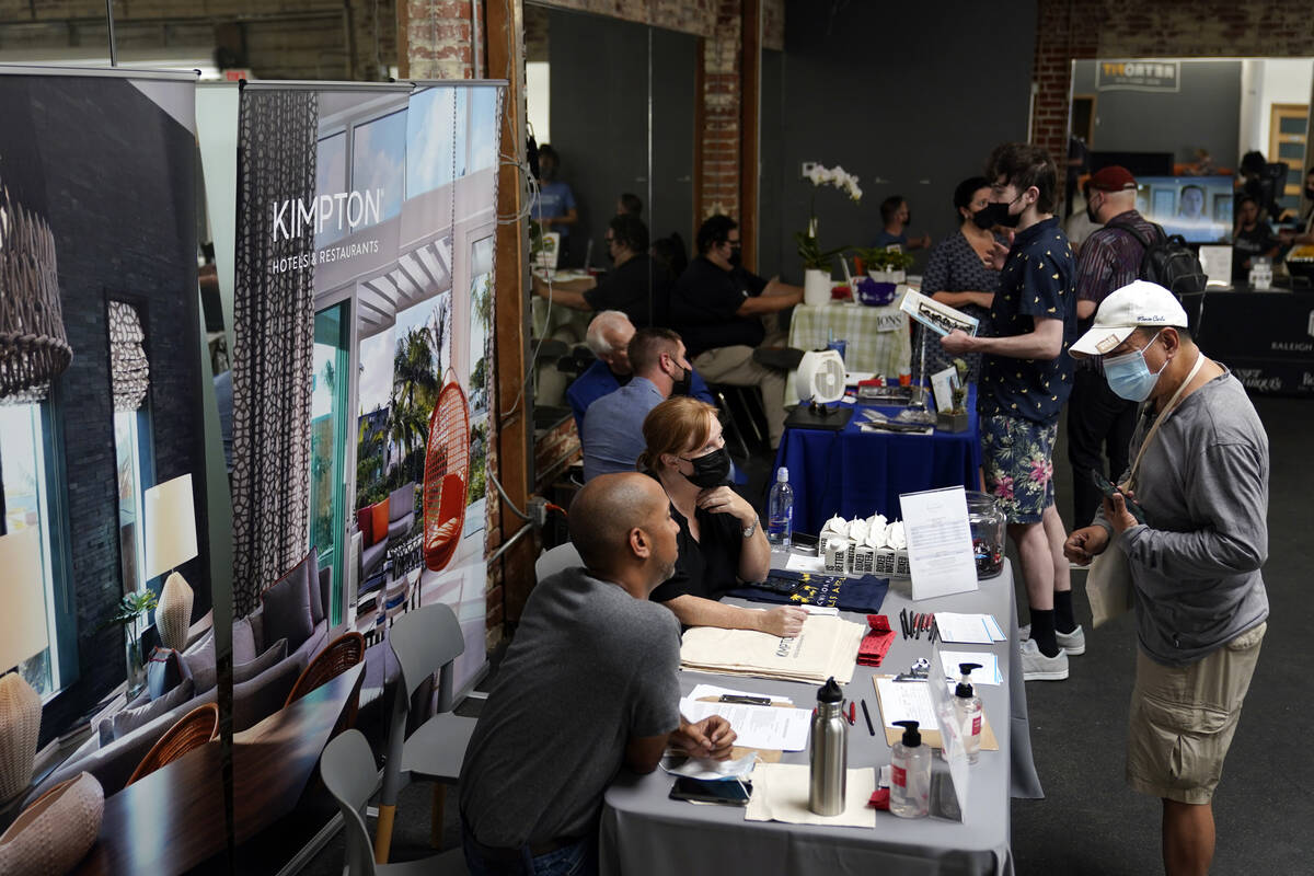 Prospective employers and job seekers interact during during a job fair on Sept. 22, 2021, in t ...