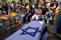 Mourners wait for the funeral for slain hostage Avraham Munder, who was killed in Hamas captivi ...