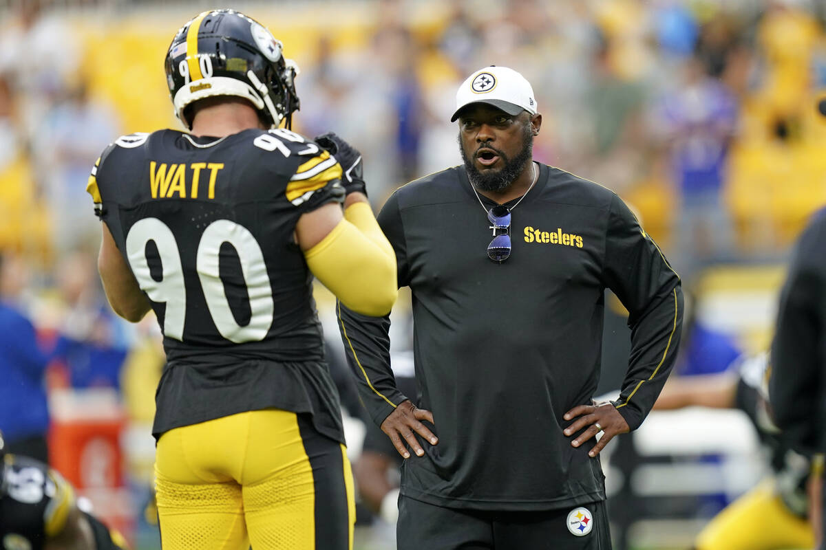 Pittsburgh Steelers head coach Mike Tomlin, right, talks with T.J. Watt (90) during warm ups be ...