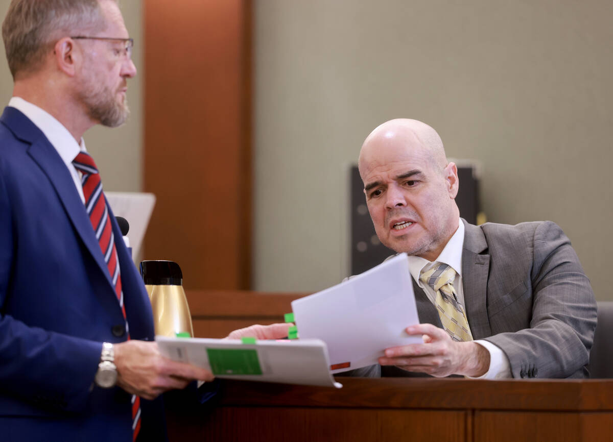 Robert Telles, right, tells his attorney Robert Draskovich which piece of evidence to put on th ...