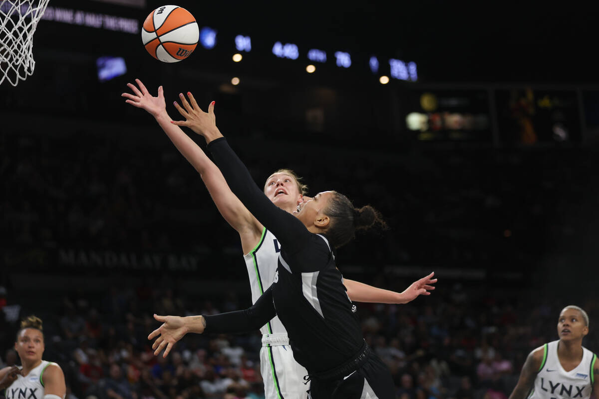 Las Vegas Aces forward Alysha Clark (7) finishes at the rim against Minnesota Lynx forward Alan ...