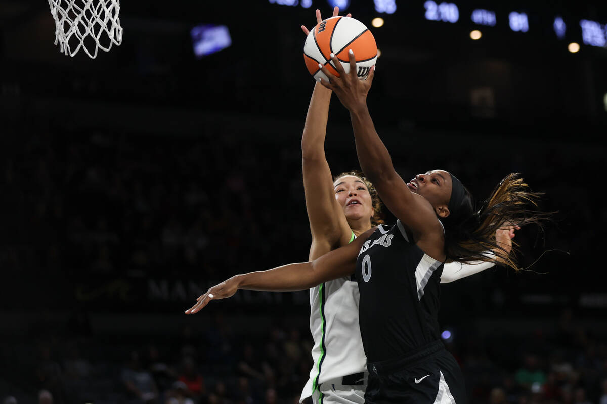 Minnesota Lynx forward Napheesa Collier, behind, thwarts a shot by Las Vegas Aces guard Jackie ...