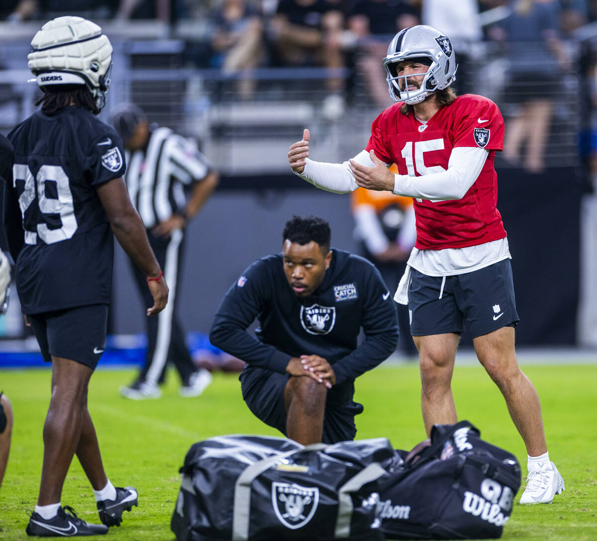 Raiders quarterback Gardner Minshew (15) consults with safety Chris Smith II (29) on a play dur ...