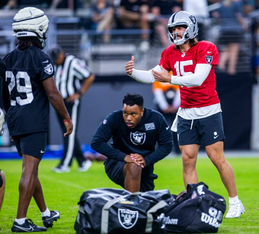 Raiders quarterback Gardner Minshew (15) consults with safety Chris Smith II (29) on a play dur ...