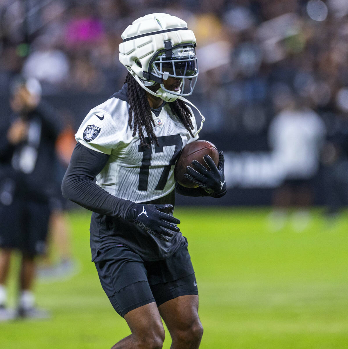 Raiders wide receiver Davante Adams (17) runs after a catch during an open practice at Allegian ...