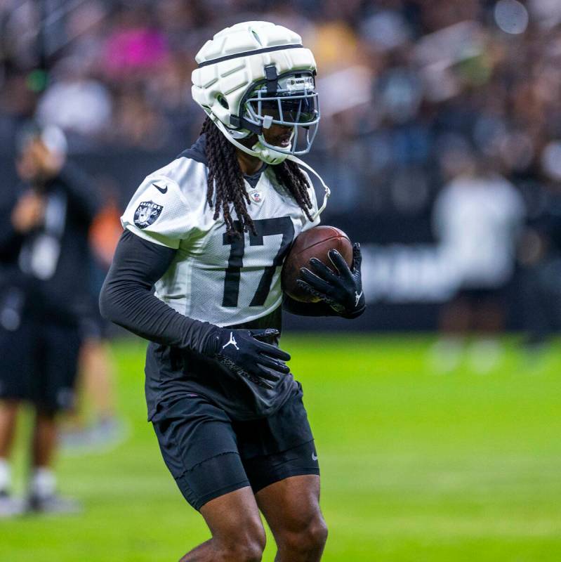 Raiders wide receiver Davante Adams (17) runs after a catch during an open practice at Allegian ...