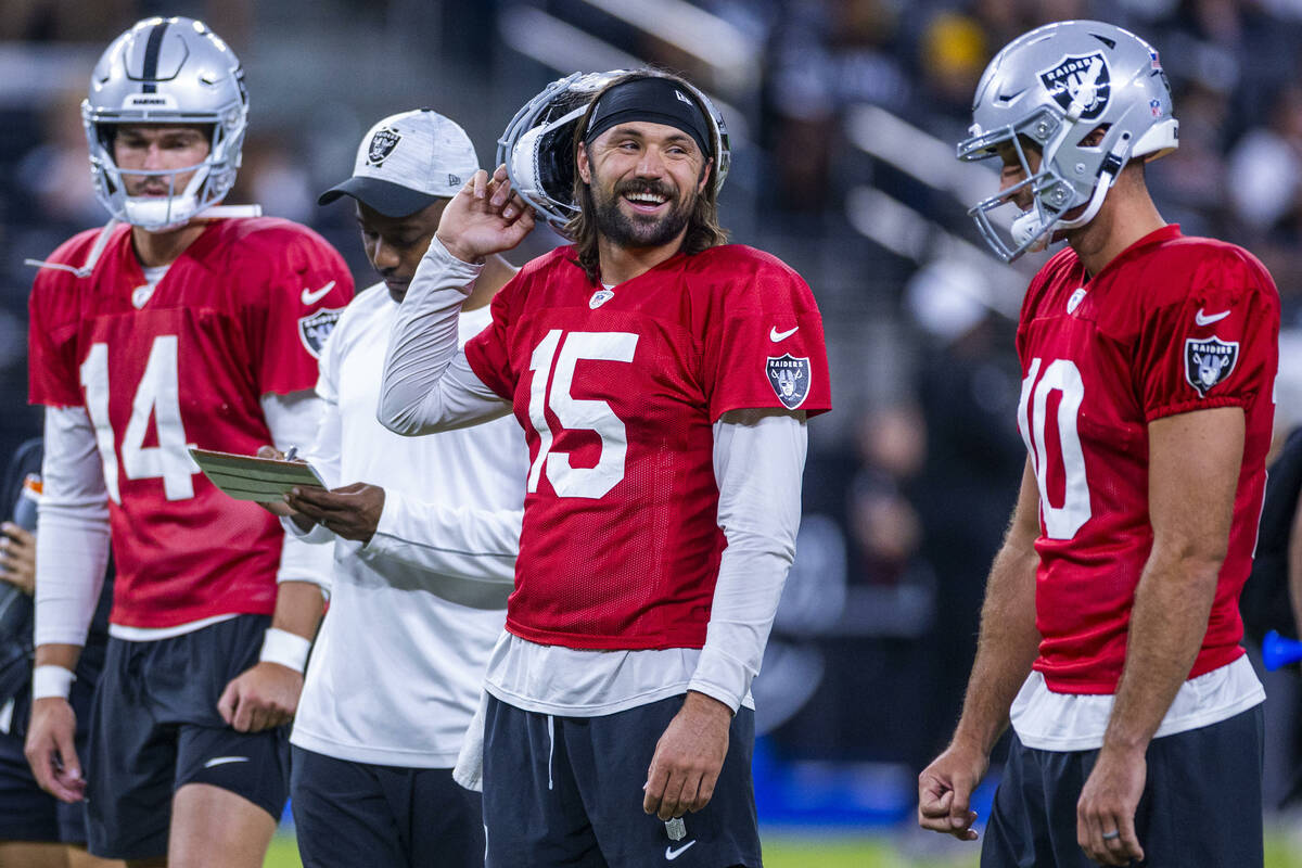 Raiders quarterback Gardner Minshew (15) laughs with quarterback Nathan Peterman (10) during an ...