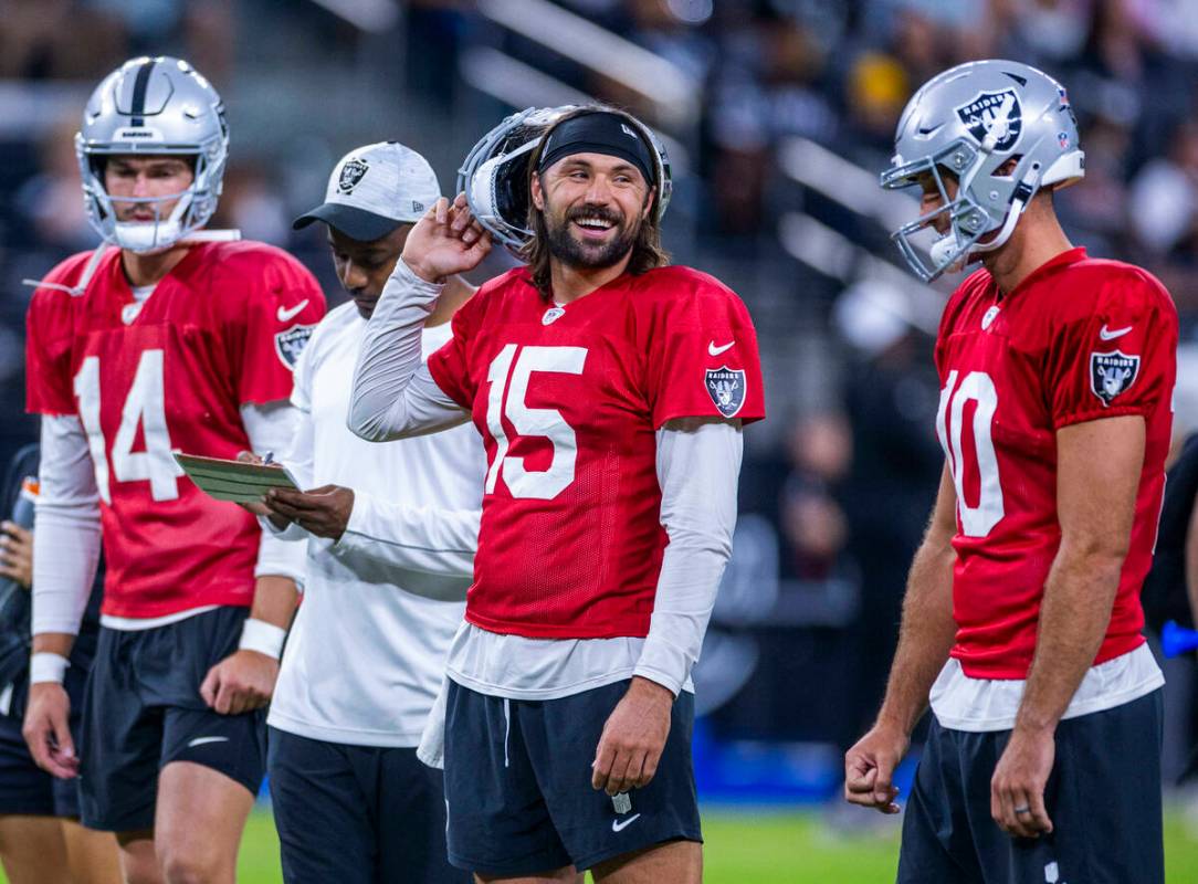 Raiders quarterback Gardner Minshew (15) laughs with quarterback Nathan Peterman (10) during an ...