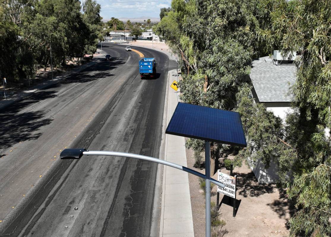 One of 12 new solar streetlights is seen at the corner of East St. Louis Avenue and Palm Street ...