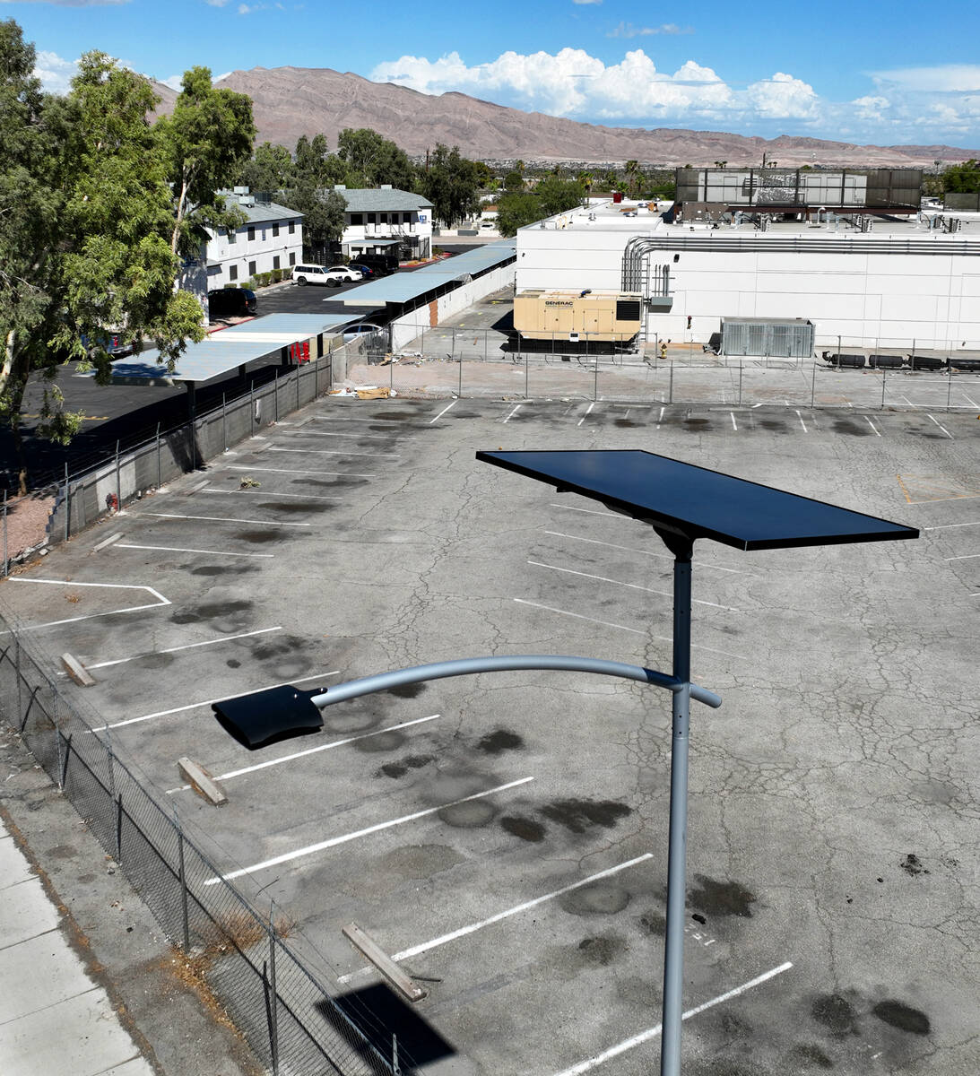 One of 12 new solar streetlights is seen at the corner of East St. Louis Avenue and Palm Street ...