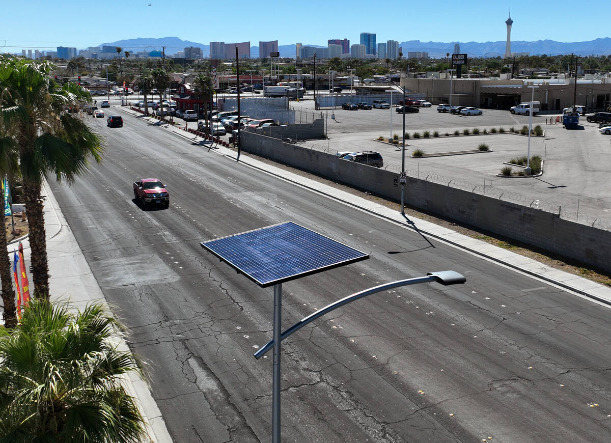 One of 12 new solar streetlights is seen at the corner of East St. Louis Avenue and Palm Street ...