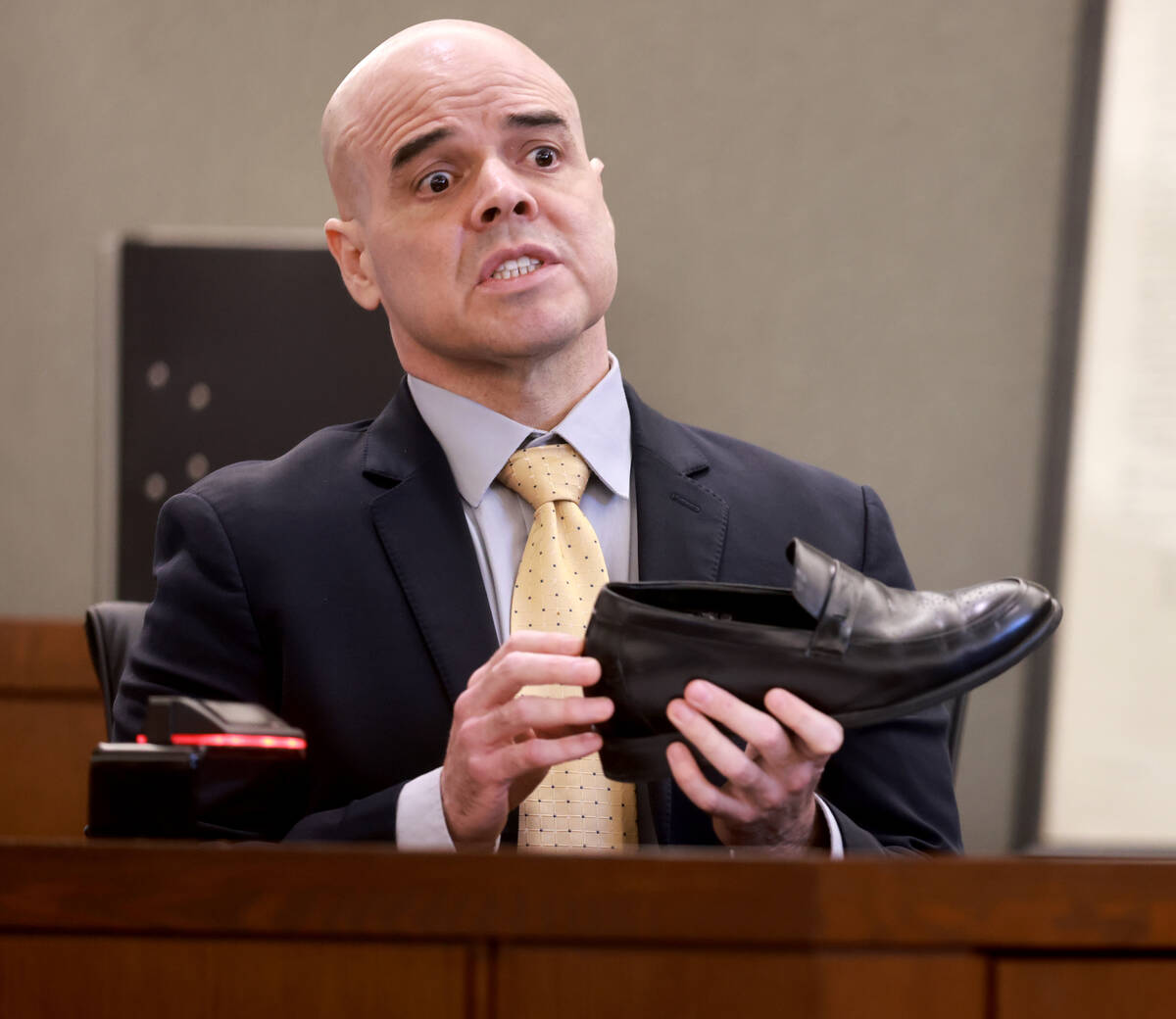 Robert Telles shows that he wears shoe lifts during his narrative on the witness stand on the n ...