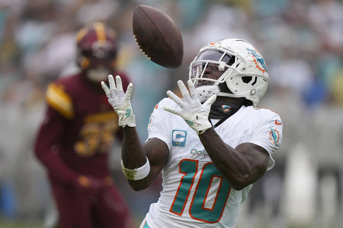 FILE - Miami Dolphins wide receiver Tyreek Hill (10) catches a touchdown pass during the first ...