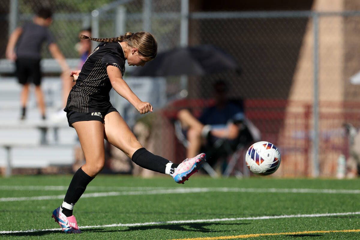 Faith Lutheran midfielder Olivia Stark kicks to score a goal during a high school soccer game a ...