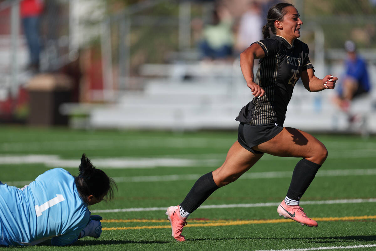 Faith Lutheran’s Riley Renteria (25) powers past Bishop Gorman goalkeeper Clara Estiadan ...