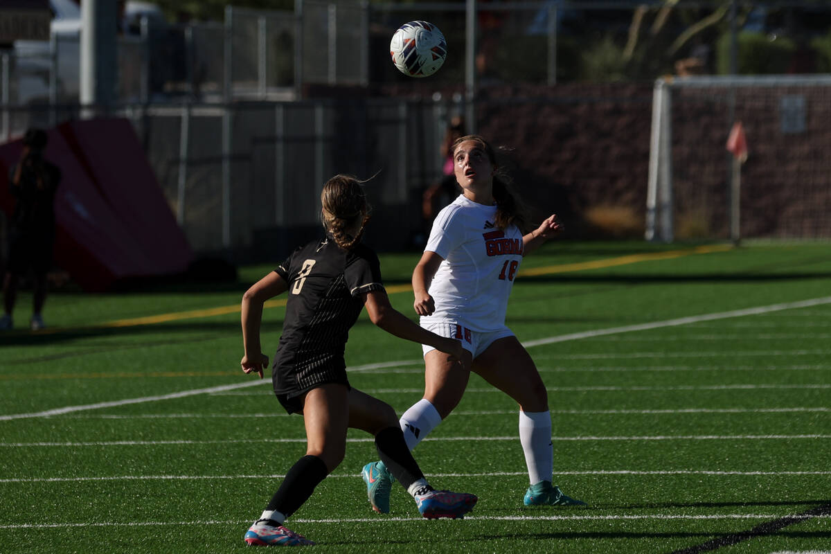 Faith Lutheran’s Olivia Stark (8) and Bishop Gorman’s Isabelle Grady (16) eye an ...