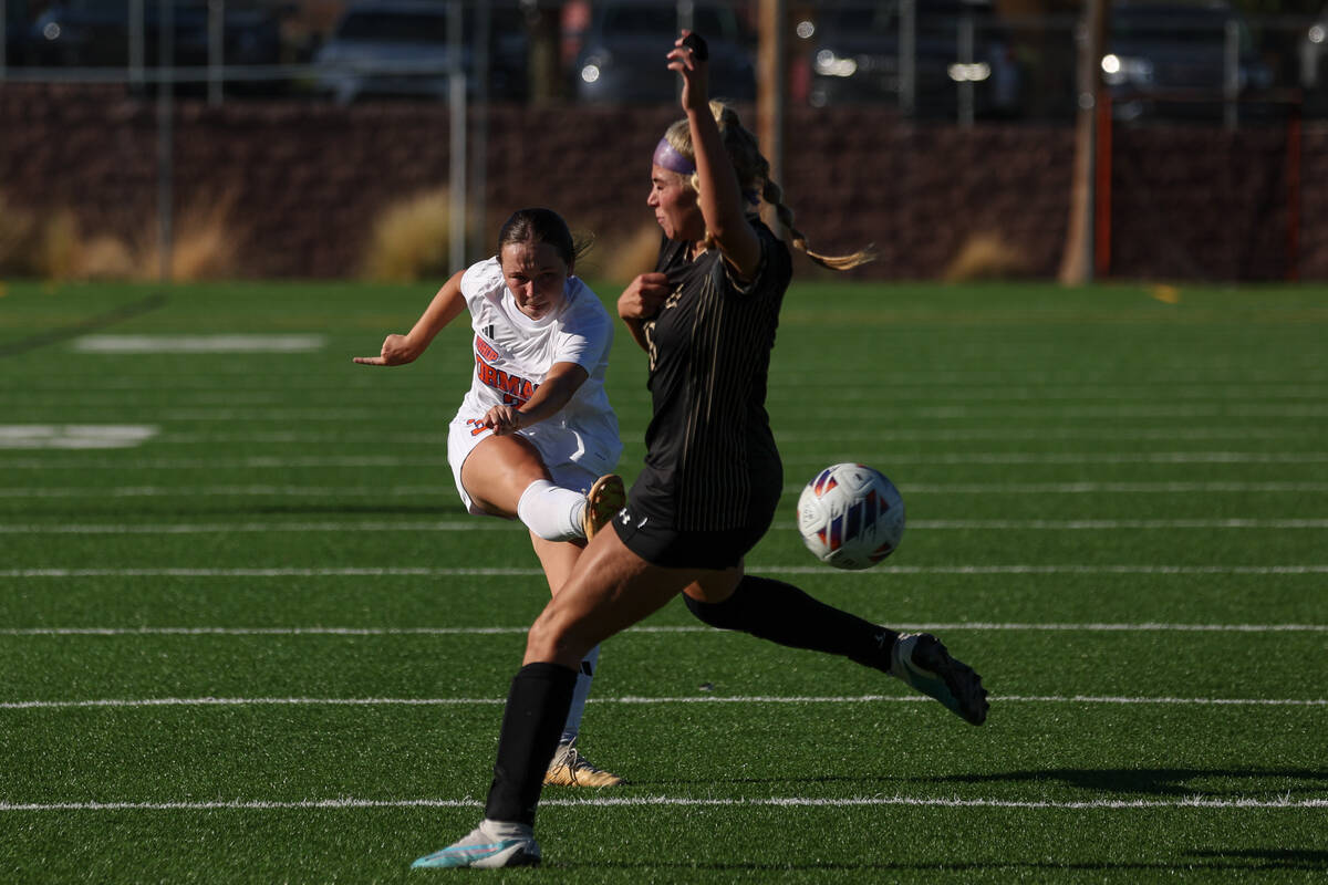 Bishop Gorman’s Emma Flannery (3) kicks the ball toward the net while Faith Lutheran&#x2 ...