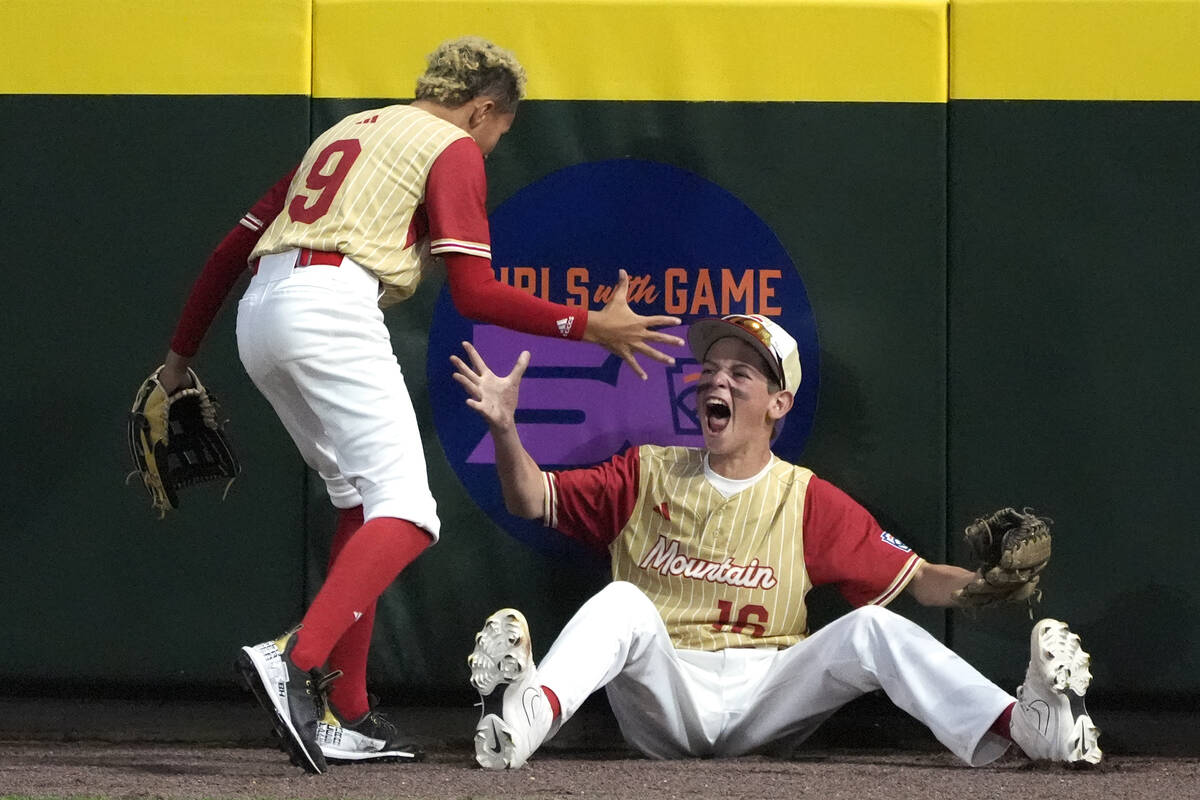 Henderson, Nev. right fielder Dominic Laino, left, celebrates with center fielder Caleb Gomez ( ...