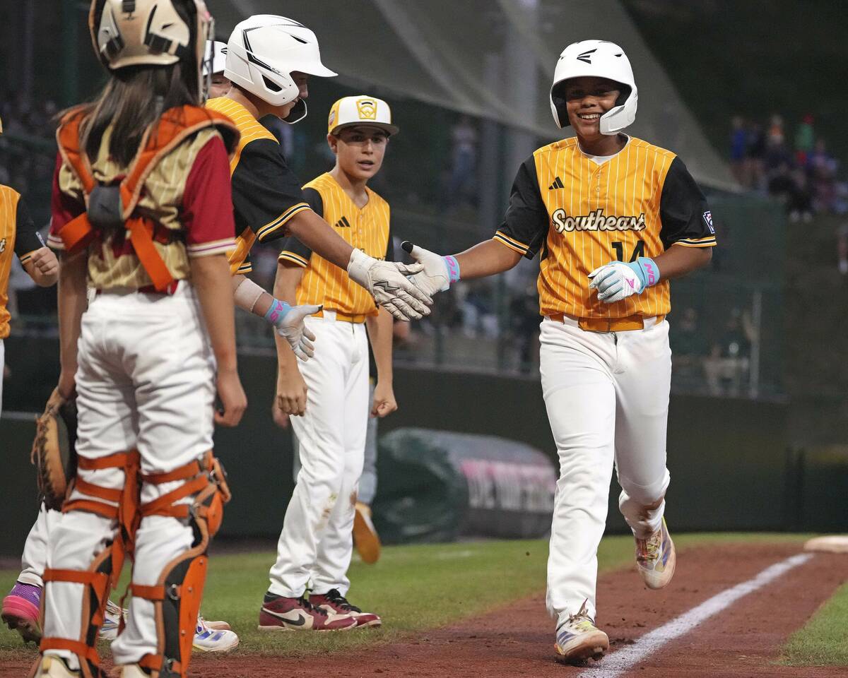 Lake Mary, Fla.'s.'s James Feliciano, right, is greeted by teammates after hitting a solo home ...