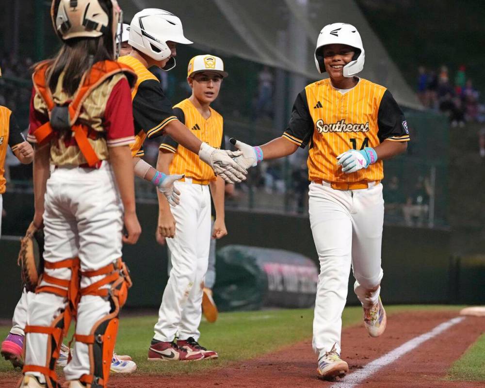 Lake Mary, Fla.'s.'s James Feliciano, right, is greeted by teammates after hitting a solo home ...