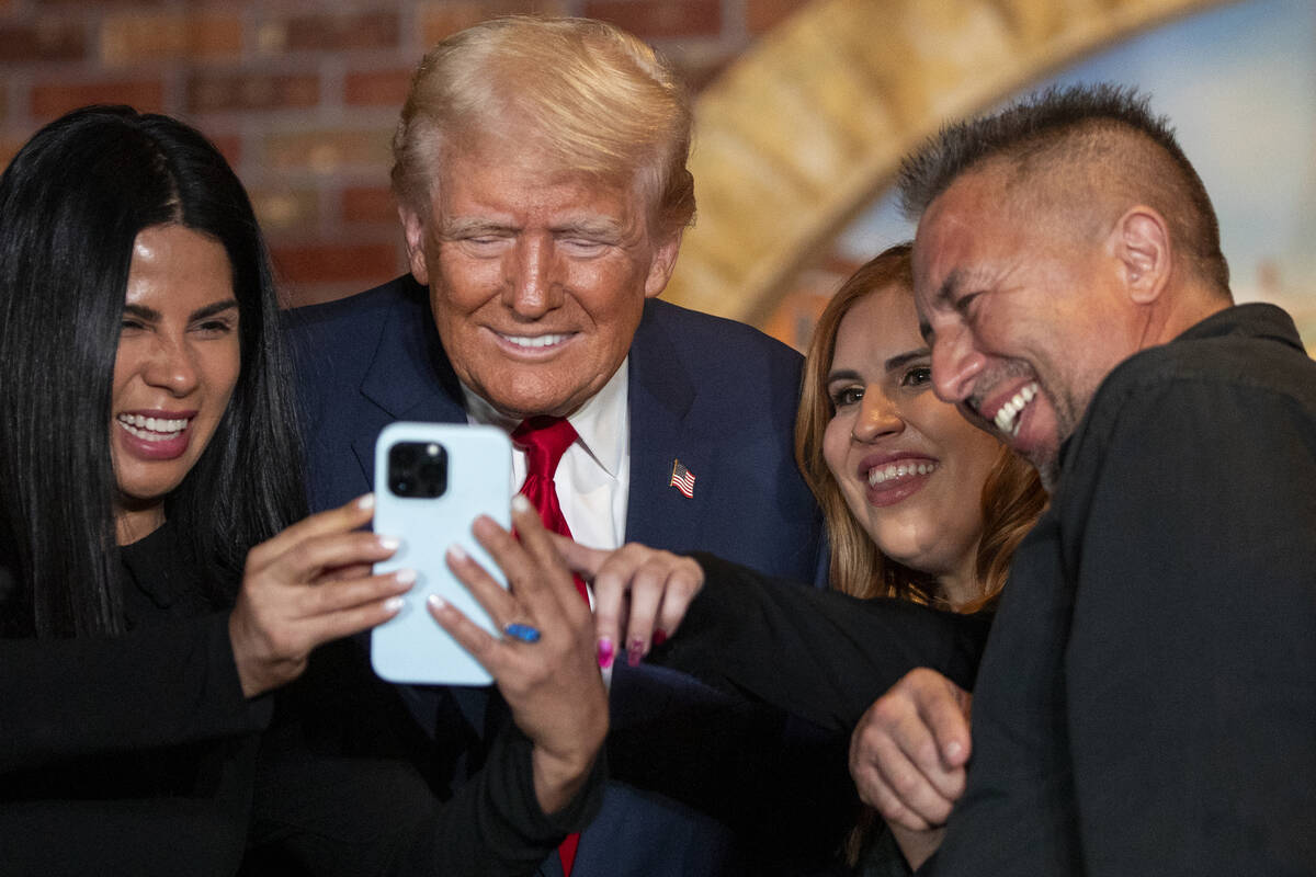 Republican presidential nominee former President Donald Trump answers a FaceTime call from memb ...