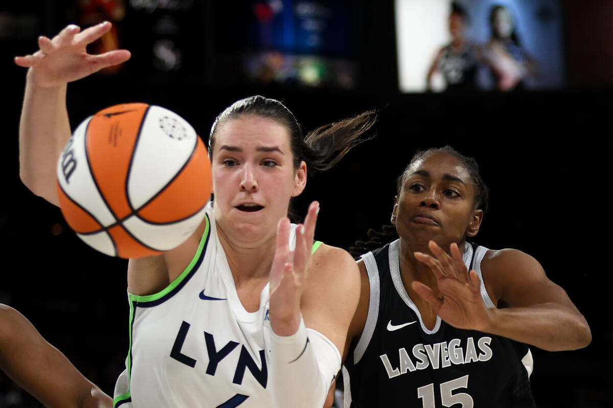 Minnesota Lynx forward Bridget Carleton, left, and Las Vegas Aces guard Tiffany Hayes (15) vie ...