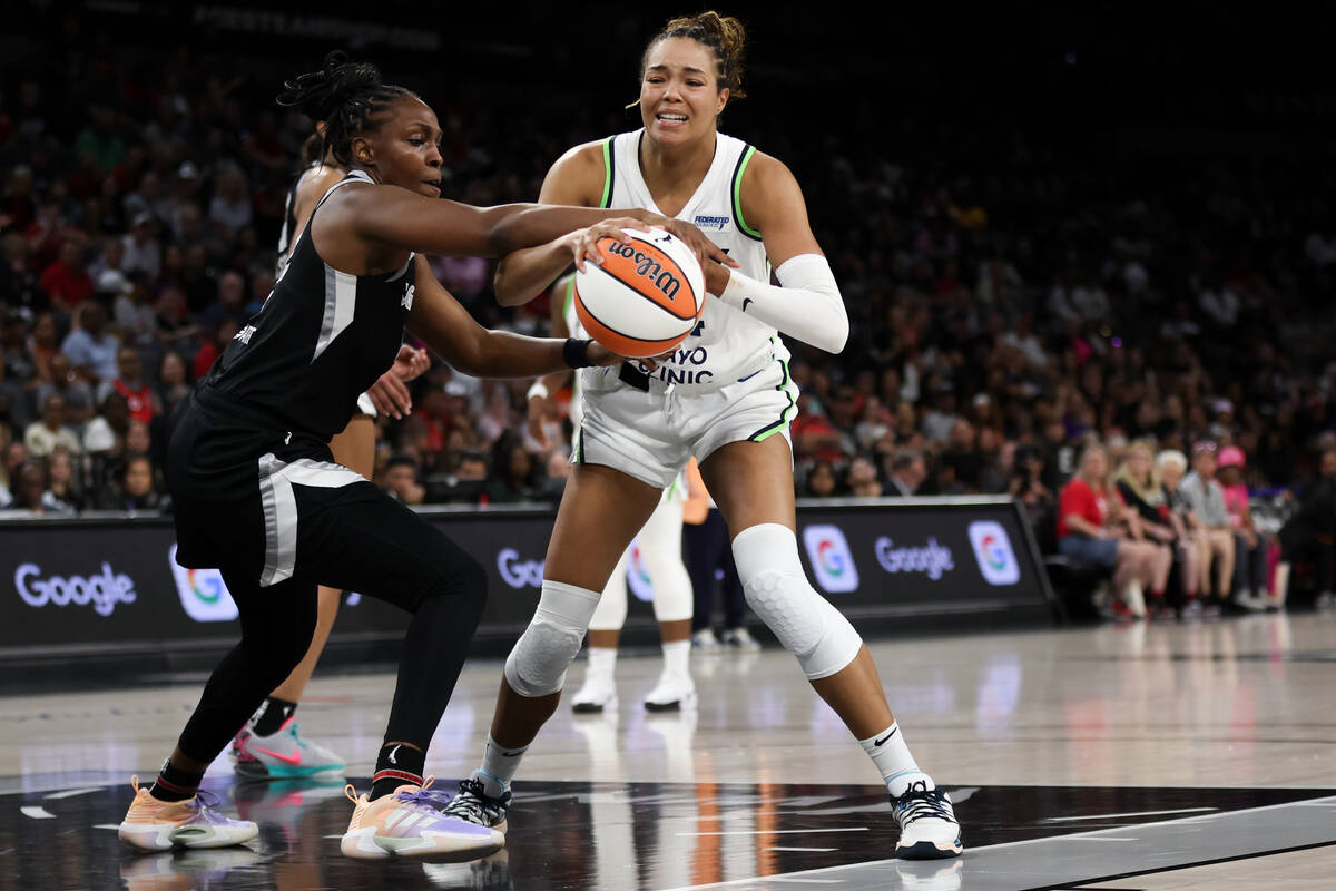 Las Vegas Aces guard Chelsea Gray, left, wrestles the ball away from Minnesota Lynx forward Nap ...