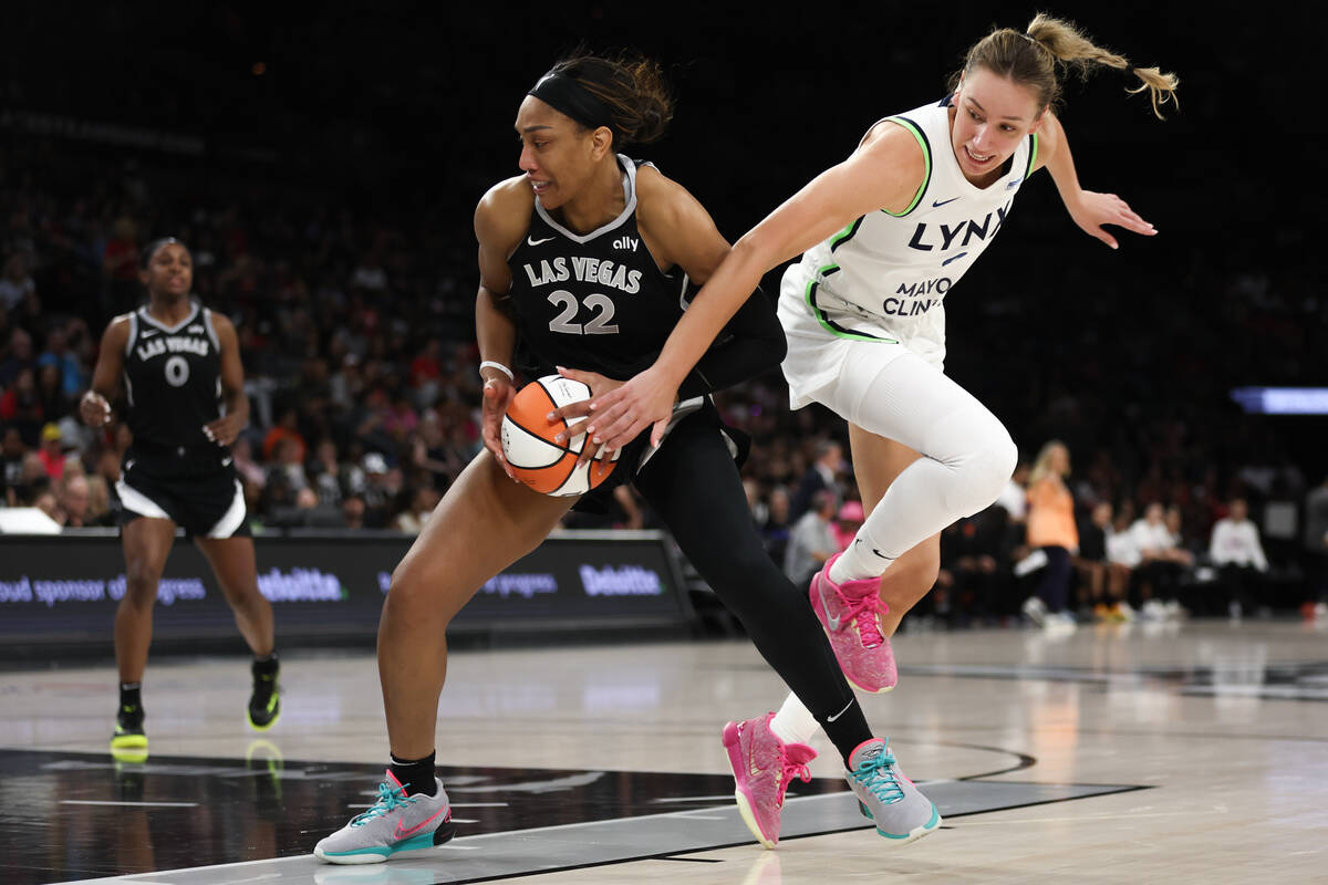 Las Vegas Aces center A'ja Wilson (22) works toward the hoop while Minnesota Lynx forward Alann ...